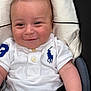 baby, child, polo_shirt, white_clothing, smiling, face, infant, sitting, cute, portrait, casual, blue_logo, skin, hand, clothing, eyes, head, young, baby_girl_boy, indoor