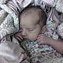 Elaina is registered to the contest to win money with this photo: newborn, baby, sleeping, blanket, soft, cozy, floral, pattern, infant, peaceful, closeup, portrait, child, cute, warm, hands, face, indoors, resting, wrapped