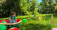 Kreg joined the competition — help win amazing prizes! toddler, inflatable_pool, grass, balloons, fruit_balloons, trees, sunny, outdoor, summer, child, greenery, blue_sky, lei, holiday, celebration, playful, colorful, signs, nature, portrait