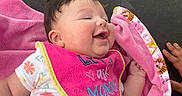 Luna is registered to the contest to win money with this photo: baby, bib, blanket, bodypart, clothing, cushion, face, happy, head, homedecor, laughing, newborn, person, photography, portrait, purple, quilt, sleeping, t_shirt, towel