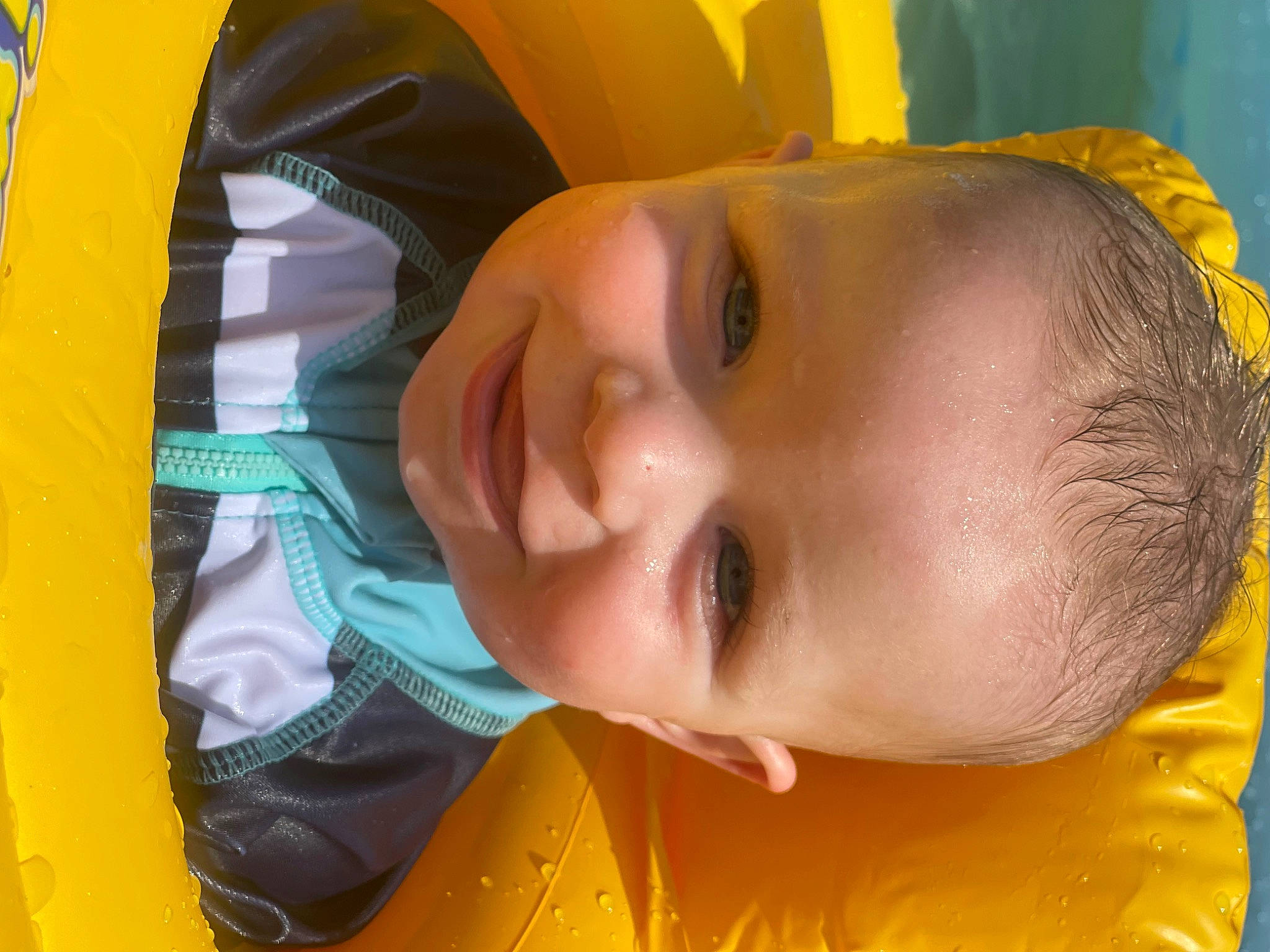 Lincoln is registered to the contest to win money with this photo: baby, cheek, chin, eyebrow, forehead, grass, hairstyle, happy, iris, leisure, lip, mouth, nose, orange, person, product, skin, smile, toddler, water