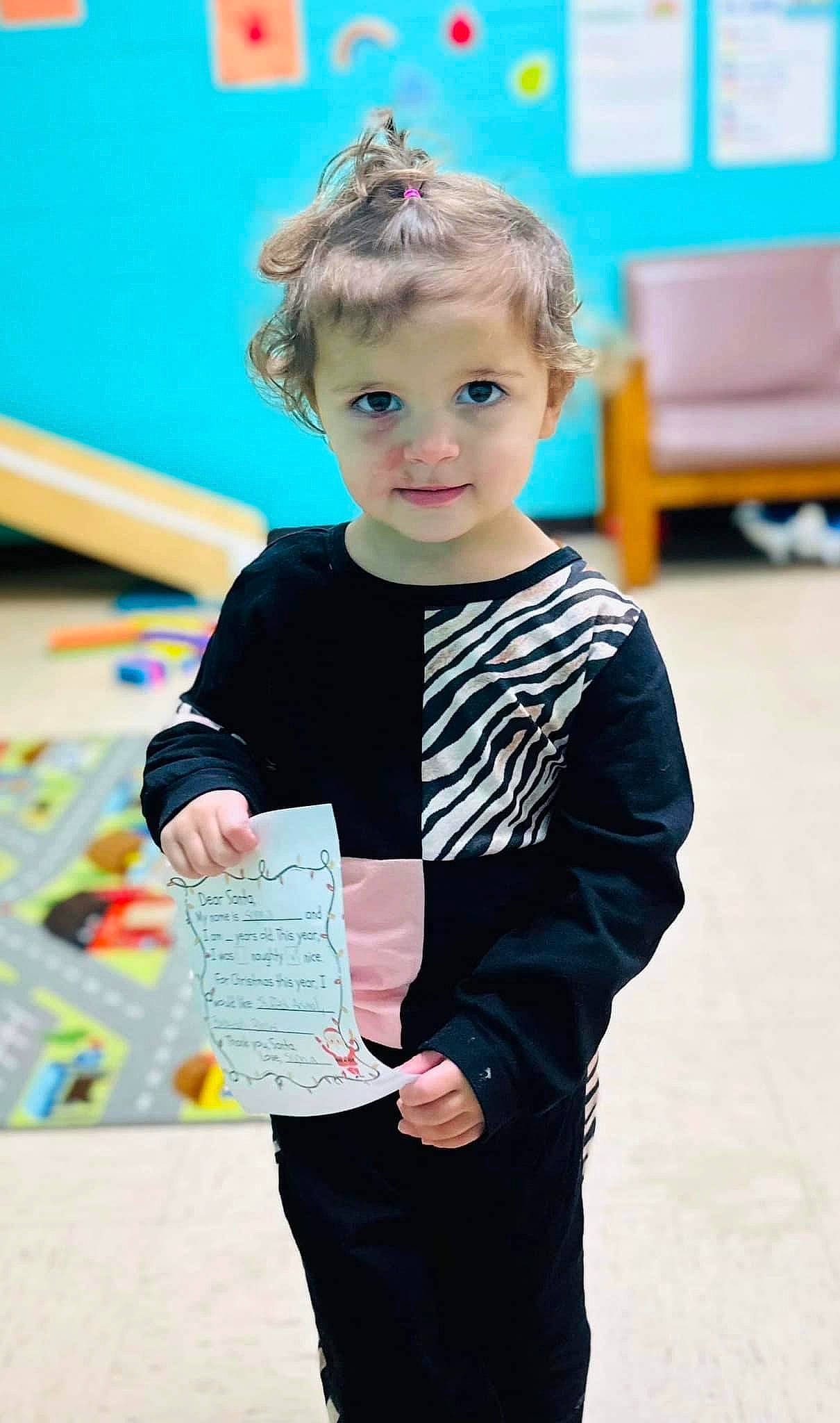 Sophia is registered to the contest to win money with this photo: child, child_art, electric_blue, event, fashion_design, fun, hairstyle, happy, leisure, pattern, person, play, room, school, sitting, sleeve, sportswear, t_shirt, toddler, visual_arts