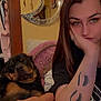 Rocko Evander joined the competition — help win amazing prizes! woman, dog, rottweiler, tattoo, face_filter, mirror, clothing, closet, indoor, relaxed, casual, portrait, home, pink_pillow, hand_on_face, brown_hair, black_tshirt, decor, seated, pet