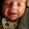Colton is registered to the contest to win money with this photo: baby, infant, smile, closed_eyes, blanket, cozy, soft_texture, sleeping, portrait, face, child, newborn, clothing, happy, closeup, peaceful, indoors, warm, resting, cute