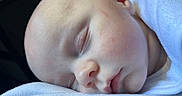 Lucas joined the competition — help win amazing prizes! baby, sleeping, infant, close_up, face, skin, peaceful, resting, blanket, white, soft, cute, newborn, child, portrait, head, calm, young, person, indoors