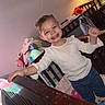 Nylah is registered to the contest to win money with this photo: baby, blanket, child, clothing, crib, cute, furniture, happy, home, indoor, jeans, lamp, long_sleeve_shirt, person, portrait, room, smiling, toddler, toy, wood