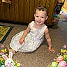 Nylah is registered to the contest to win money with this photo: carpet, celebration, child, cute, decorations, dress, easter, easter_bunny, easter_eggs, festive, flowers, happy, holiday, holiday_frame, indoor, person, playful, smiling, toddler, wooden_cabinet