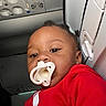 Dnero joined the competition — help win amazing prizes! child, pacifier, red_clothing, airplane, seat, face, infant, portrait, window, ceiling, interior, transportation, young_child, baby, person, close_up, expression, travel, seatbelt, casual