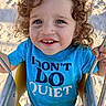 Asher is registered to the contest to win money with this photo: child, toddler, curly_hair, blue_eyes, swing, playground, sand, smiling, blue_shirt, text_on_shirt, outdoor, sunny, happy, play, cute, young_child, holding, seat, metal_chains, fun