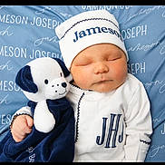 Jameson is registered to the contest to win money with this photo: newborn, baby, sleeping, infant, stuffed_animal, plush_toy, blue_blanket, white_outfit, hat, personalized_blanket, cuddling, cute, child, soft_toy, monogram, cozy, portrait, indoors, resting, peaceful