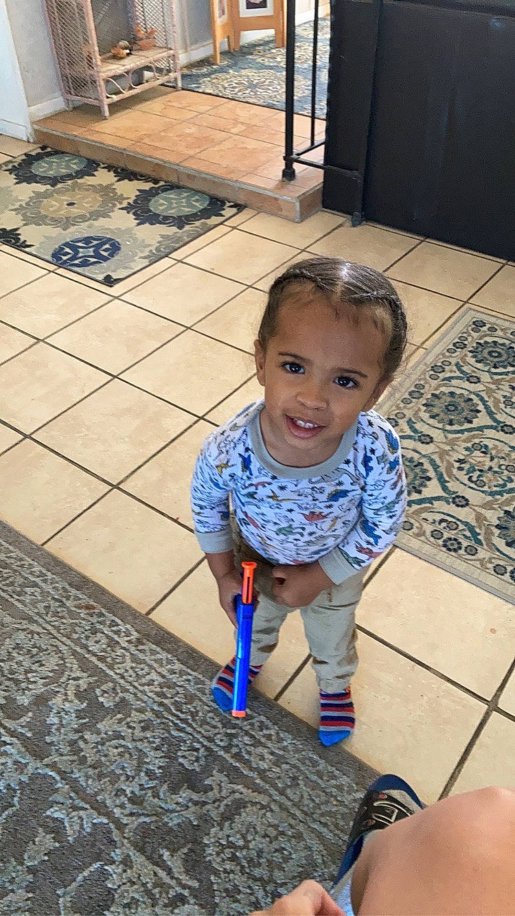 Darren is registered to the contest to win money with this photo: child, electric_blue, event, floor, flooring, fun, happy, head, human_leg, joy, leisure, pattern, person, recreation, road_surface, sidewalk, sitting, smile, snapshot, toddler