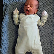 Jahziah joined the competition — help win amazing prizes! baby, infant, onesie, sleepy, yawning, blanket, blue_blanket, newborn, clothing, cute, face, person, indoors, laying_down, soft_texture, child, small_hands, cozy, resting, sleep