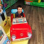 Chemsey a rejoint le concours — aidez-le/la à gagner de superbes lots ! child, smiling, toy_car, indoor, play_area, boy, happy, colorful, flooring, plastic, amusement, fun, seat, vehicle, cute, young, playing, recreation, joyful, leisure