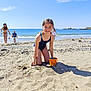 child, girl, beach, sand, bucket, swimsuit, ocean, sea, sky, sunny, playing, summer, shoreline, water, vacation, kids, outdoor, happy, smiling, holiday