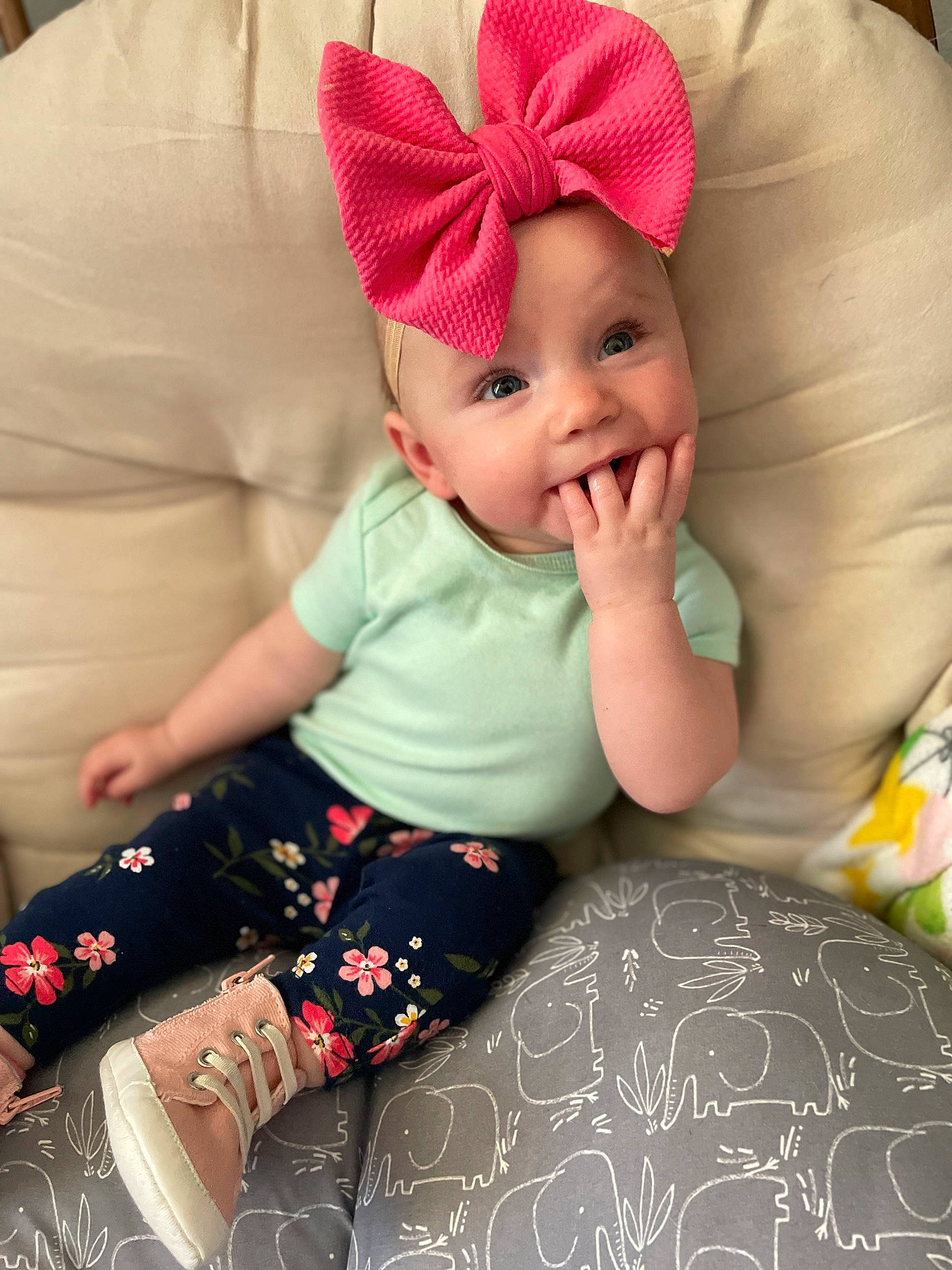Rowyn is registered to the contest to win money with this photo: baby, baby_toddler_clothing, cap, child, comfort, happy, head, headwear, human_body, human_leg, lap, magenta, pattern, person, pink, skin, sleeve, sock, textile, thigh