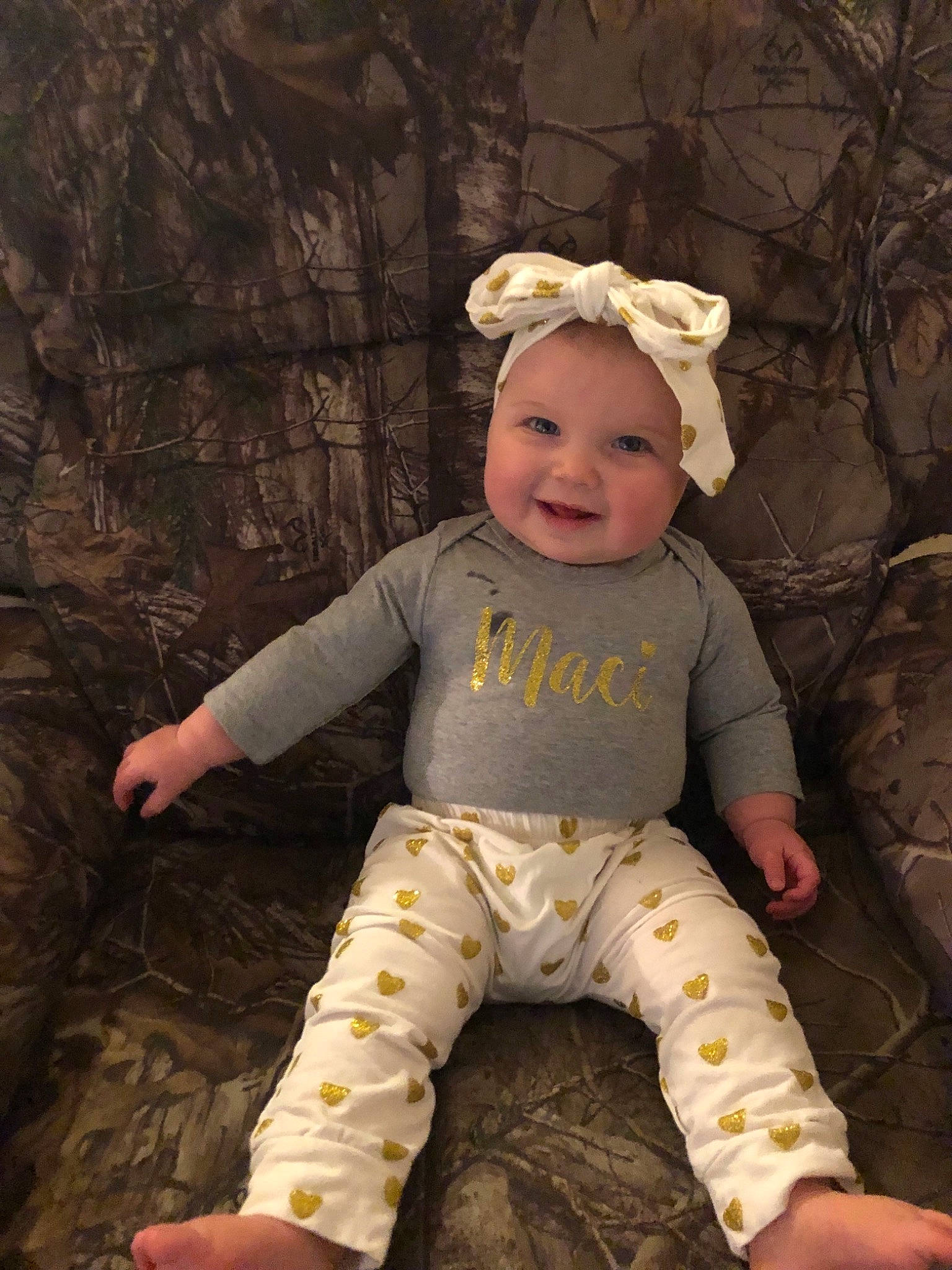 Maci is registered to the contest to win money with this photo: child, girl, hair_accessory, headgear, infant, joy, person, product, smile, toddler, yellow