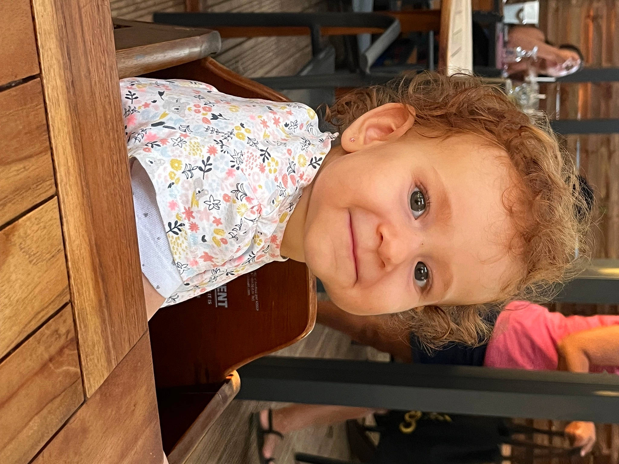 Lola participe au concours pour gagner de l'argent avec cette photo : baby, baby_products, baby_toddler_clothing, cheek, child, eye, facial_expression, flooring, fun, happy, hardwood, iris, joy, nose, person, room, sitting, skin, smile, toddler