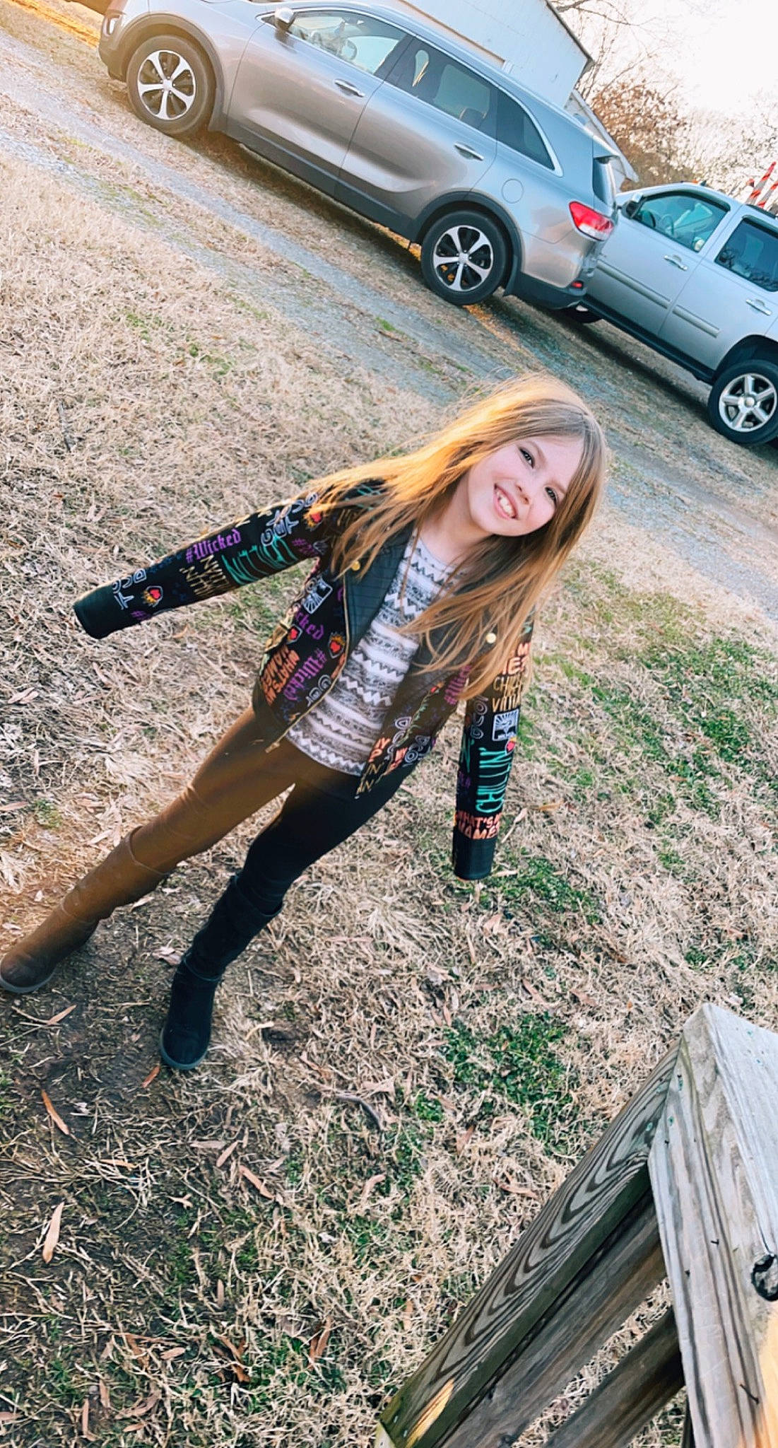 Grayleigh is registered to the contest to win money with this photo: alloy_wheel, asphalt, automotive_design, automotive_lighting, automotive_tire, black_hair, car, footwear, grass, joy, knee, leg, motor_vehicle, person, photograph, road_surface, shoe, street_fashion, thigh, tire