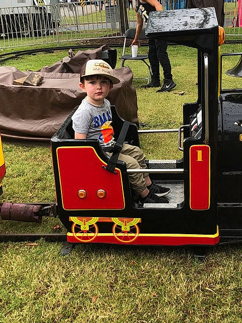 Jaxson joined the competition — help win amazing prizes! headwear, person, play, playground, public_space, train, transport, vehicle