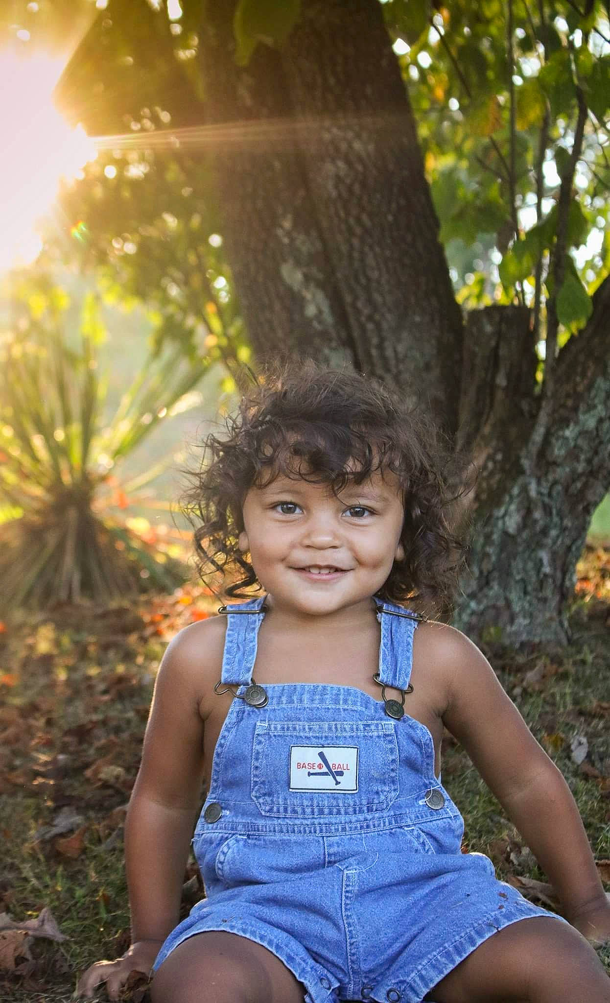 Prince is registered to the contest to win money with this photo: child, child_model, fun, happy, joy, leisure, people_in_nature, person, photo_shoot, photograph, photography, portrait_photography, sitting, smile, summer, sunlight, tree, vacation