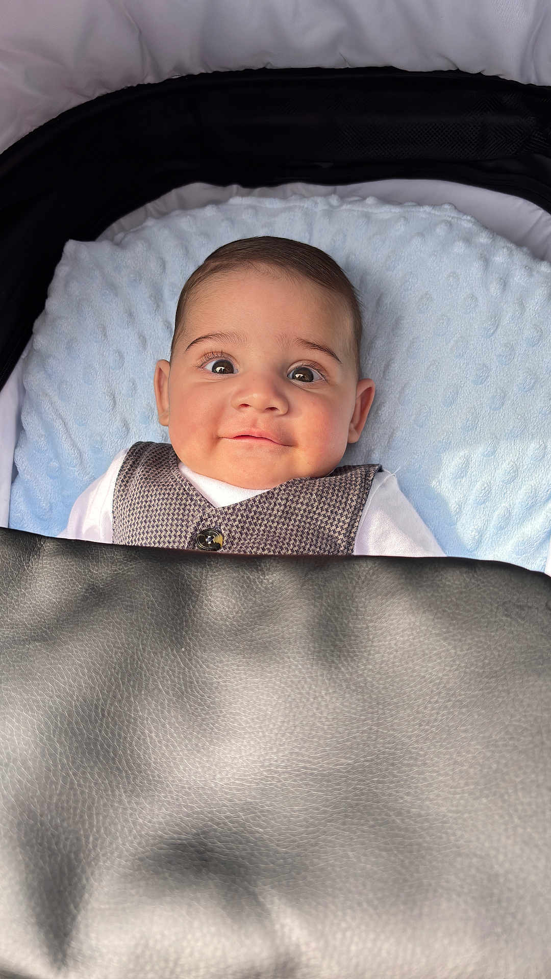 Tibor joined the competition — help win amazing prizes! baby, infant, stroller, face, eyes, clothing, vest, white_shirt, blanket, leather_cover, expression, child, cute, indoor, closeup, head, skin, person, newborn, portrait