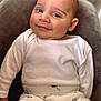 Tibor joined the competition — help win amazing prizes! baby, infant, smile, face, eyes, white_shirt, patterned_pants, cars, hot_air_balloon, cushion, gray_background, seated, comfortable, clothing, closeup, soft_lighting, indoors, cute, young_child, portrait