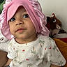 Zayan joined the competition — help win amazing prizes! toddler, child, pink_bonnet, curious, indoor, stuffed_animals, soft_toys, white_shirt, patterned_clothing, shorts, face, portrait, cute, young_child, playful, seated, expression, home, cozy, colorful