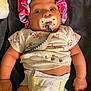 baby, bonnet, child, clothing, cute, diaper, expression, fist, floral_pattern, indoor, infant, lying_down, newborn, pacifier, person, pink, purple, skin, small_hands, towel