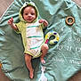Lyo participe au concours pour gagner de l'argent avec cette photo : baby, infant, child, green_clothing, frog_hood, milestone_blanket, wooden_floor, giraffe_illustration, wooden_ring, number_two, lying_down, cute_outfit, soft_toy, age_marker, baby_pose, calm_expression, indoors, flooring, baby_garment, play_mat