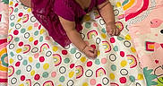 Rain joined the competition — help win amazing prizes! baby, child, purple_dress, play_mat, rainbows, polka_dots, colorful, infant, cute, smiling, indoors, floor, toddler, patterned, clothing, person, happy, portrait, lying_down, young_child