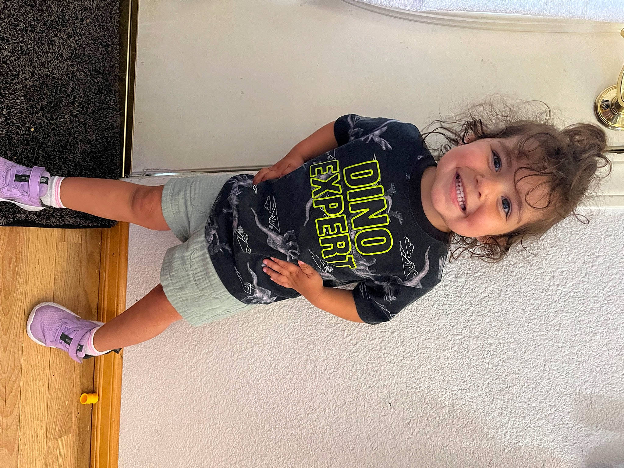 Ava is registered to the contest to win money with this photo: arm, baby_toddler_clothing, denim, elbow, flooring, fun, happy, human_leg, joint, joy, knee, leg, outdoor_shoe, person, smile, t_shirt, thigh, tire, toddler, waist