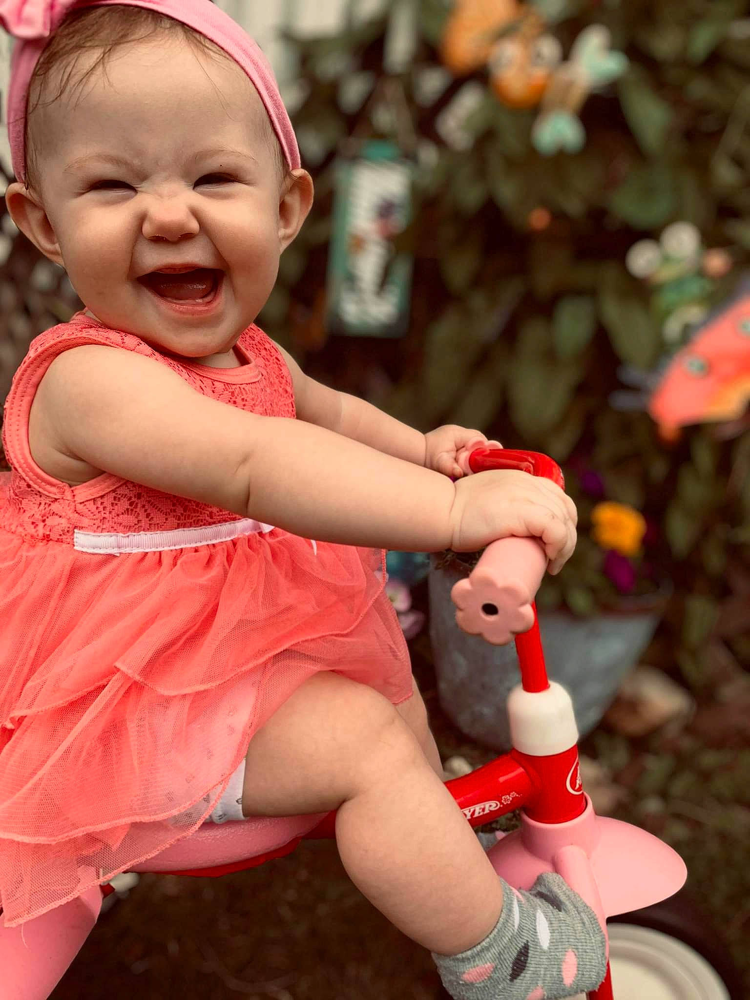 Carolina is registered to the contest to win money with this photo: baby, baby_laughing, baby_toddler_clothing, child, facial_expression, finger, fun, grass, happy, human_leg, magenta, people_in_nature, person, pink, shoe, skin, smile, standing, thigh, toddler