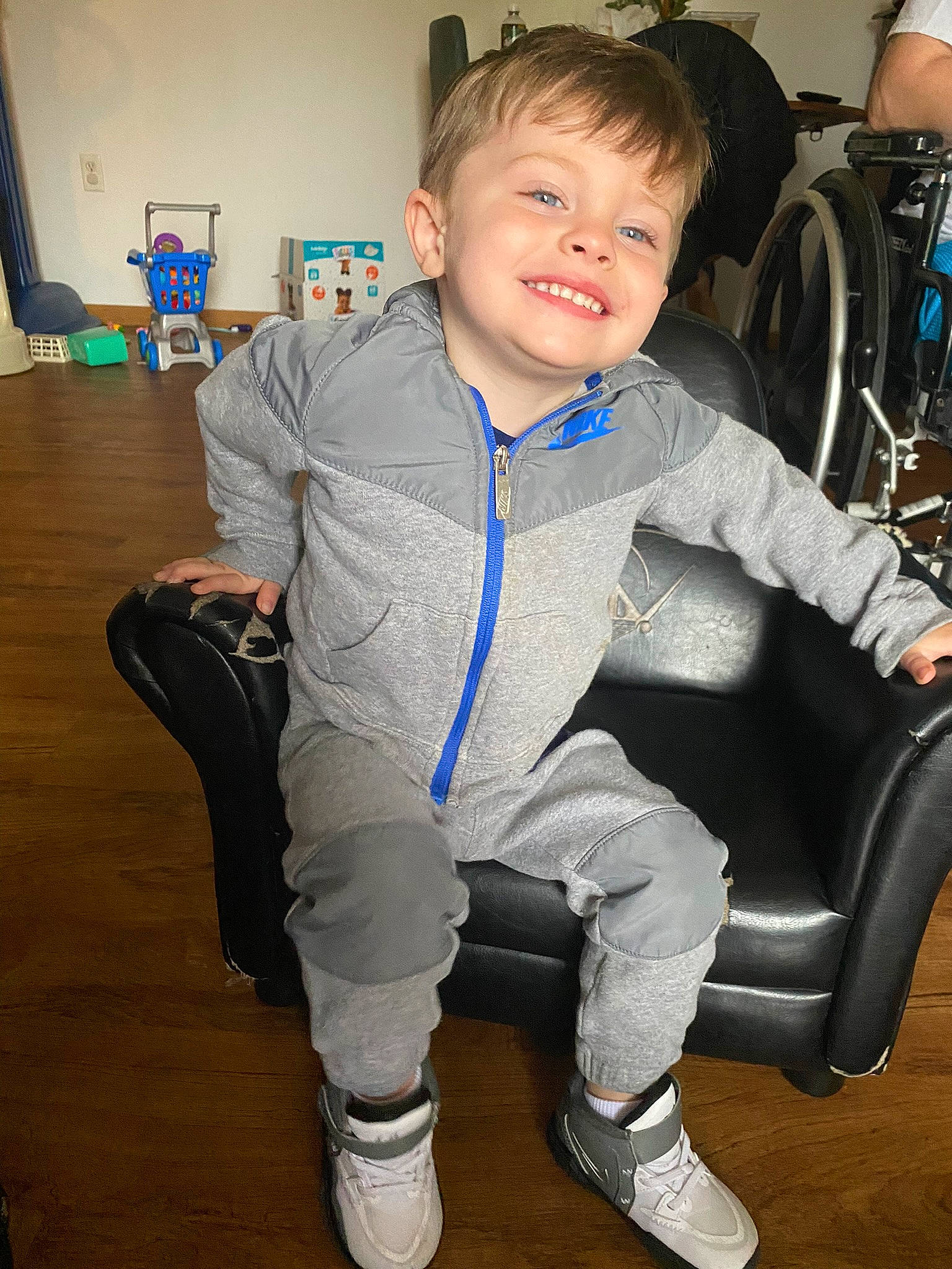 Draco joined the competition — help win amazing prizes! chair, child, comfort, electric_blue, floor, flooring, footwear, fun, hairstyle, joint, joy, knee, lap, leg, person, shoe, sleeve, smile, sneakers, standing