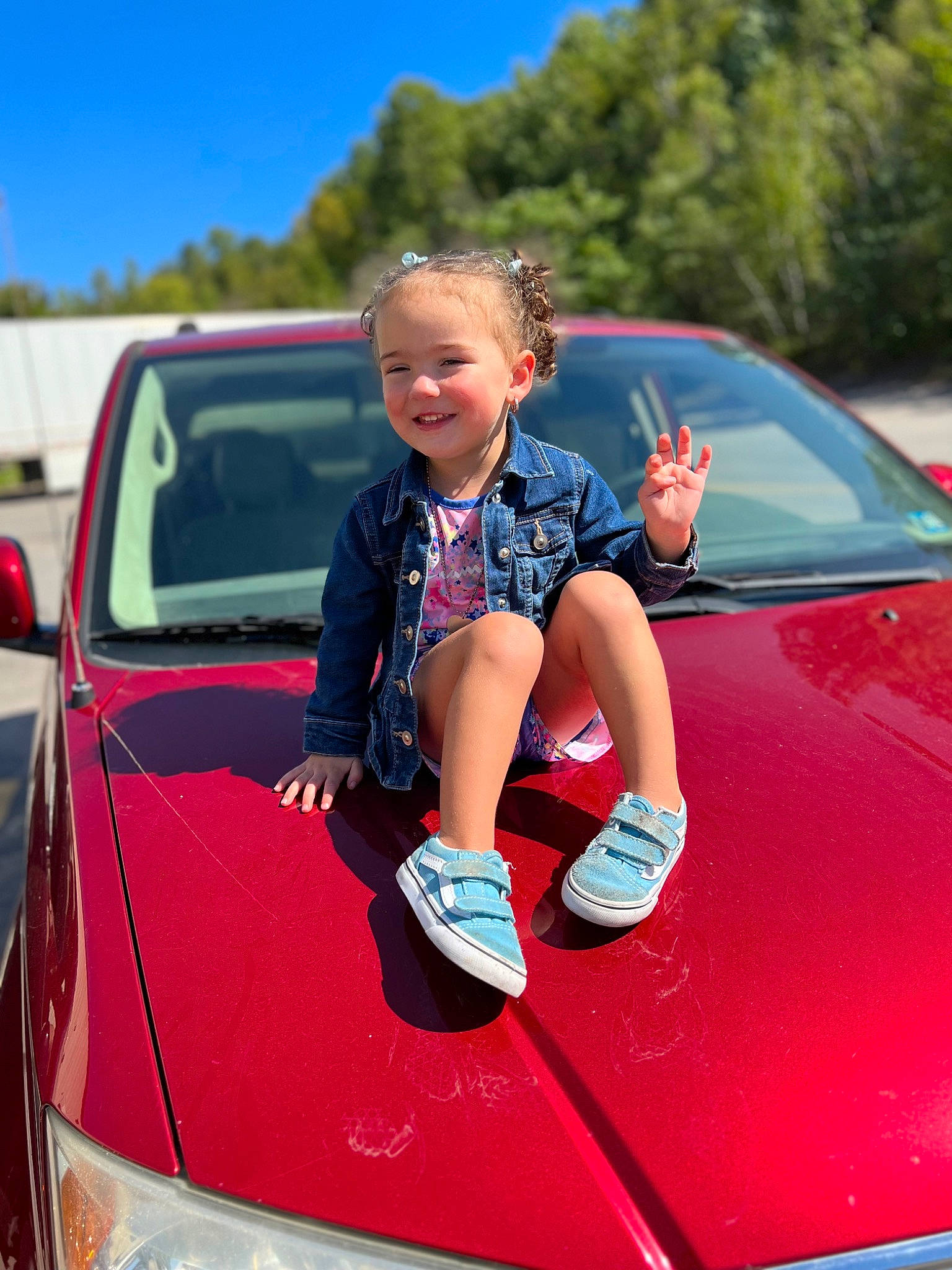 Annalee is registered to the contest to win money with this photo: automotive_design, automotive_exterior, automotive_lighting, bumper, car, grille, hood, joy, land_vehicle, motor_vehicle, person, personal_luxury_car, pink, rim, sky, smile, tints_and_shades, tree, trunk, vehicle