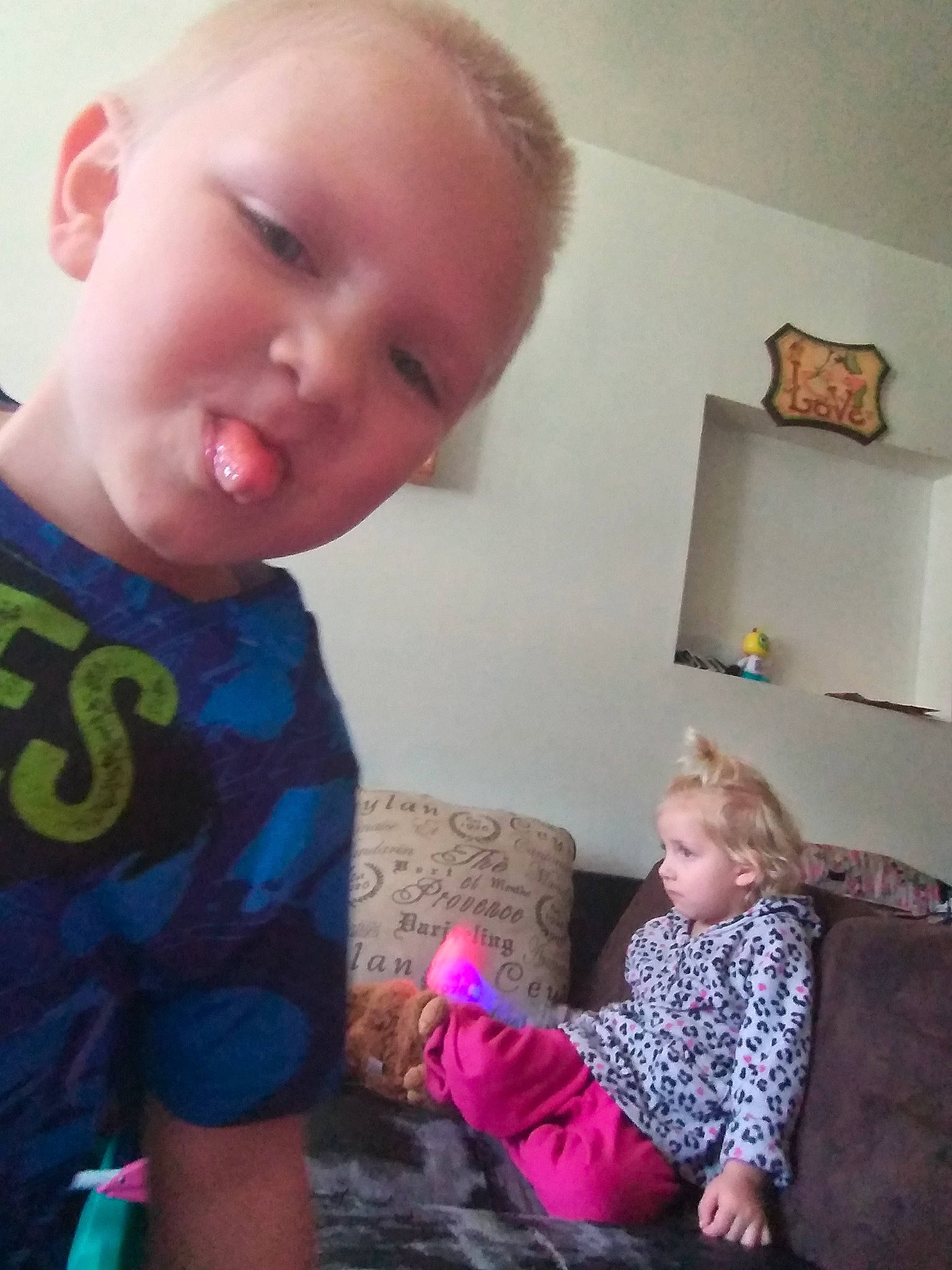 Jeffery is registered to the contest to win money with this photo: baby, cheek, child, ear, electronic_device, eye, finger, fun, neck, nose, person, pink, play, sitting, skin, toddler