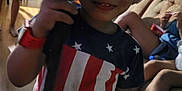 Jay'Von is registered to the contest to win money with this photo: blue, casual, child, couch, family, hat, home, indoor, people, person, red, shirt, smile, stars, stick, stripes, sunglasses, watch, white, wooden_floor
