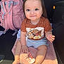 baby, child, smiling, tshirt, dog_print, pink_blanket, pacifier, car_interior, backseat, shorts, barefoot, cute, happy, toy, infant, young_child, clothing, seat, accessory, sunlight