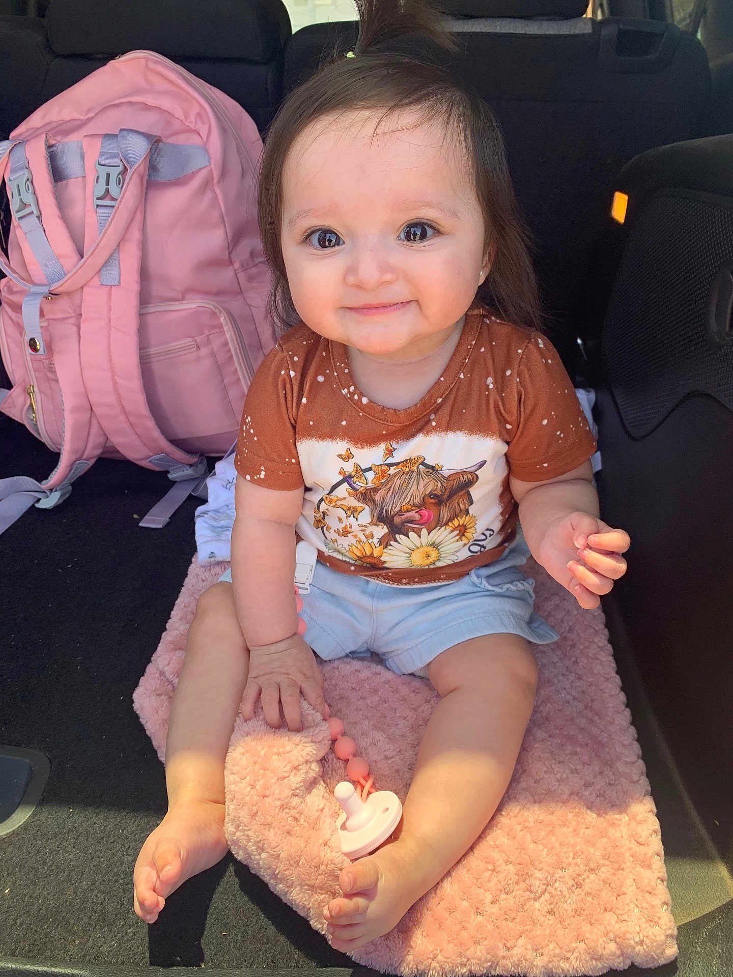 Kehlani joined the competition — help win amazing prizes! baby, child, smiling, tshirt, dog_print, pink_blanket, pacifier, car_interior, backseat, shorts, barefoot, cute, happy, toy, infant, young_child, clothing, seat, accessory, sunlight