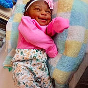 So'Lana Addison joined the competition — help win amazing prizes! baby, infant, smiling, winking, pink_clothing, headband, flower_accessory, blanket, patterned_pants, socks, lying_down, cute, happy, child, indoors, soft_toys, cozy, newborn, portrait, baby_girl