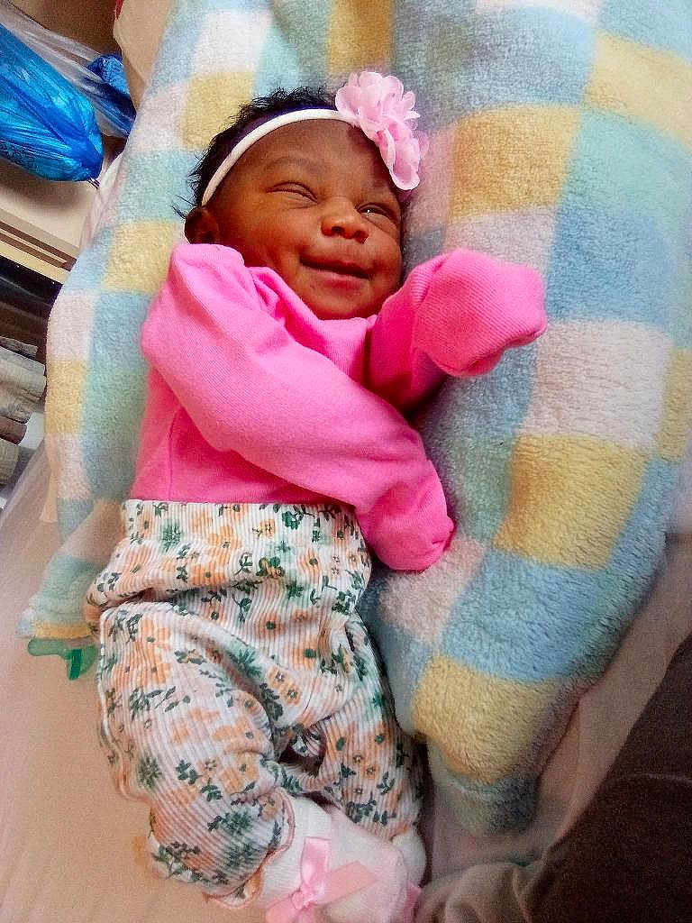 So'Lana Addison joined the competition — help win amazing prizes! baby, infant, smiling, winking, pink_clothing, headband, flower_accessory, blanket, patterned_pants, socks, lying_down, cute, happy, child, indoors, soft_toys, cozy, newborn, portrait, baby_girl