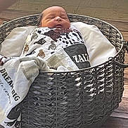 Zaizen is registered to the contest to win money with this photo: newborn, baby, basket, blanket, sleeping, wooden_floor, woven, cozy, indoor, child, wrapped, peaceful, infant, patterned_blanket, resting, cute, small, portrait, calm, home