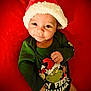 Zaizen joined the competition — help win amazing prizes! baby, infant, santa_hat, christmas, holiday, green_onesie, grinch, red_blanket, smile, cute, festive, portrait, child, lying_down, holiday_clothing, happy, indoors, seasonal, cozy, person