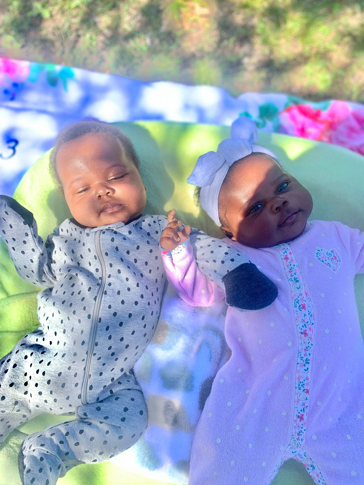 Kayla is registered to the contest to win money with this photo: baby, baby_toddler_clothing, child, event, fun, grass, happy, interaction, leisure, organism, people_in_nature, person, pink, plant, play, purple, recreation, spring, sunglasses, textile