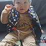 toddler, child, baby, sitting, sweater, vest, hat, pacifier, couch, leather, clothing, face, foot, hand, indoor, window, curious, expression, person, young