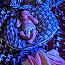 baby, pillow, blanket, dog, carpet, floor, indoor, sleeping, pattern, diaper, soft, cozy, pet, resting, child, animal, comfort, cute, laying, blue_light