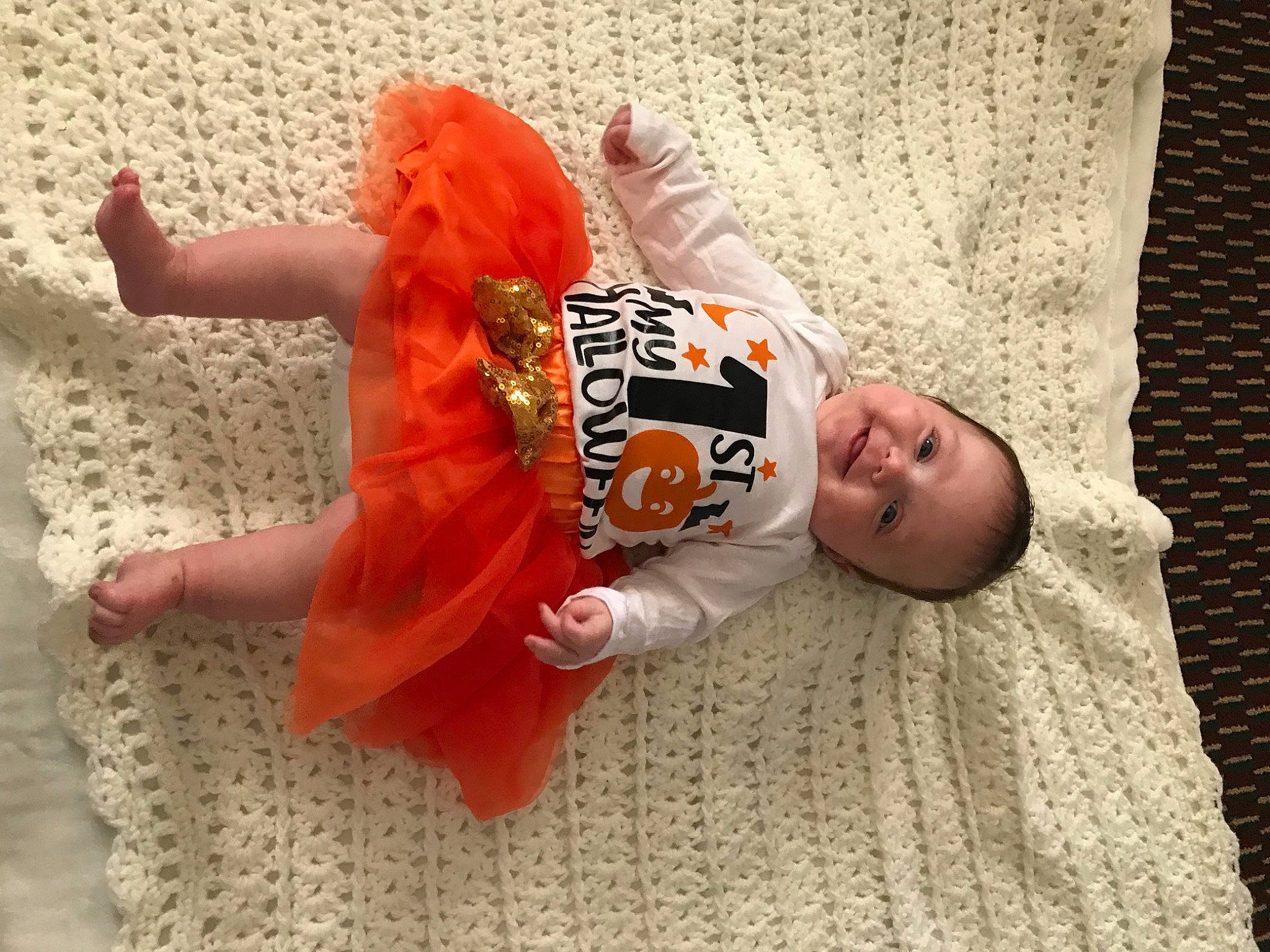 Lezley is registered to the contest to win money with this photo: baby, baby_toddler_clothing, carmine, child, comfort, floor, flooring, foot, fun, human_leg, joy, leg, linens, pattern, person, sitting, sleeve, smile, sock, t_shirt