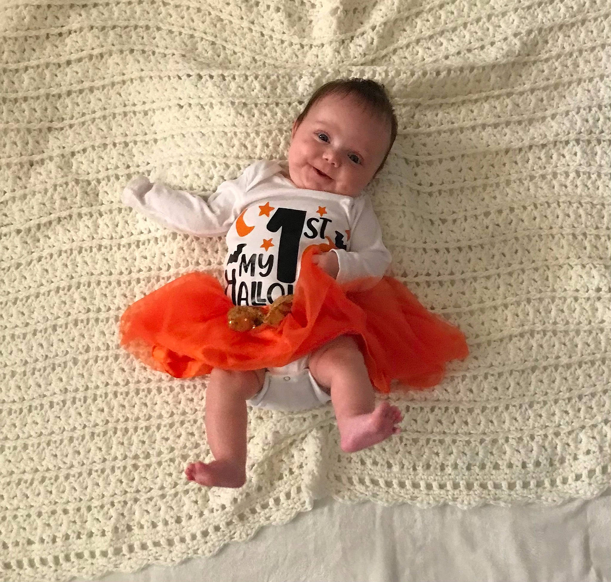 Lezley is registered to the contest to win money with this photo: baby, baby_products, baby_toddler_clothing, child, comfort, flooring, font, fun, happy, linens, pattern, peach, person, room, sitting, sleeve, smile, t_shirt, textile, thigh