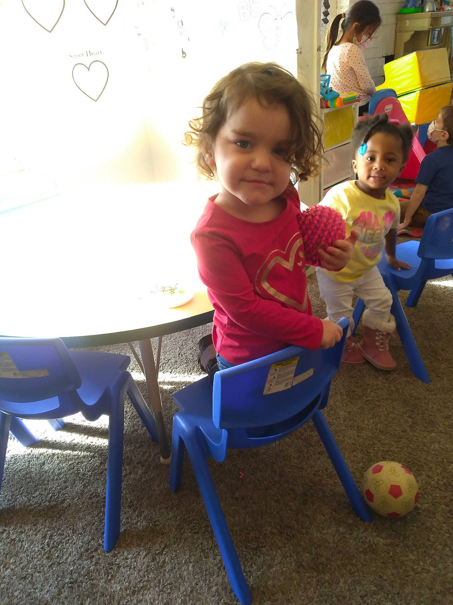 Melody joined the competition — help win amazing prizes! baby_playing_with_toys, baby_toddler_clothing, blue, chair, child, fun, happy, leisure, person, photograph, recreation, room, shorts, sitting, smile, snapshot, t_shirt, table, toddler, toy