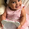 5_months, baby, bow, celebration, child, chubby_cheeks, couch, cute, girl, happy, headband, indoor, infant, pink_dress, portrait, ruffles, sign, sitting, smile, soft_lighting