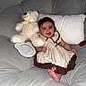 5_months, baby, child, clothing, couch, cute, dress, feet, happy, home, indoors, infant, milestone, person, pillow, plush_toy, portrait, sitting, smiling, teddy_bear